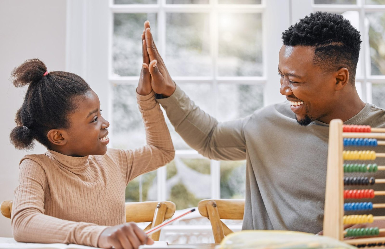 A parent and child celebrating, with the child's performance summary from ClarityBase